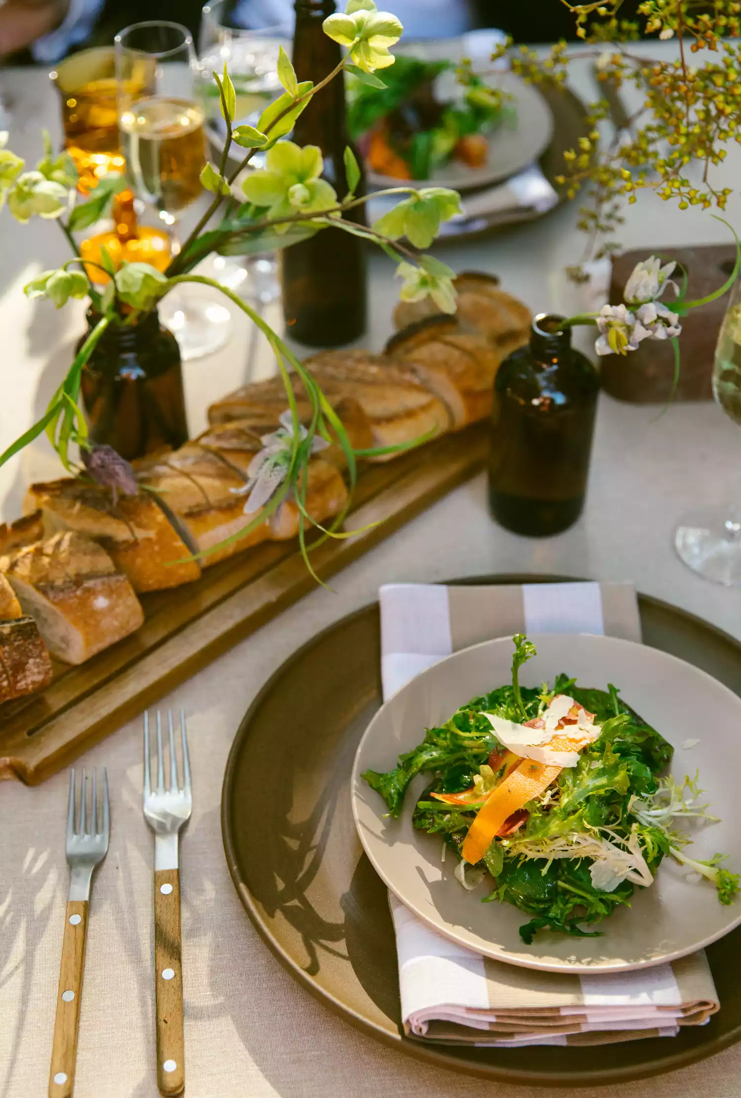 dinner table with a salad and loaf of cut bread