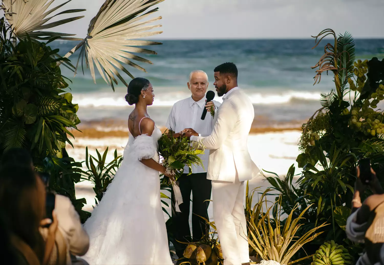 bride and groom exchanging vows seaside
