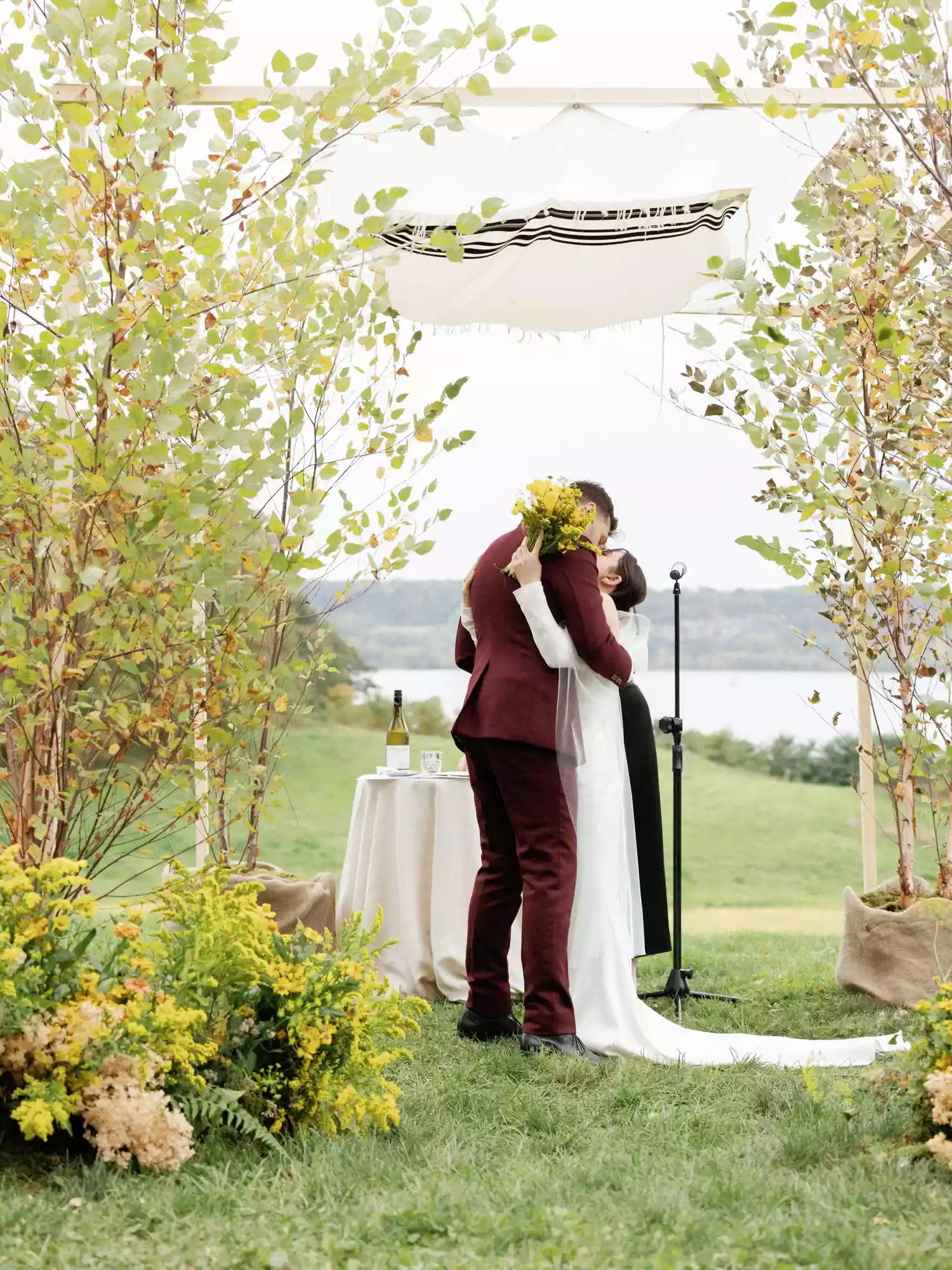 bride and groom kiss under the chuppah