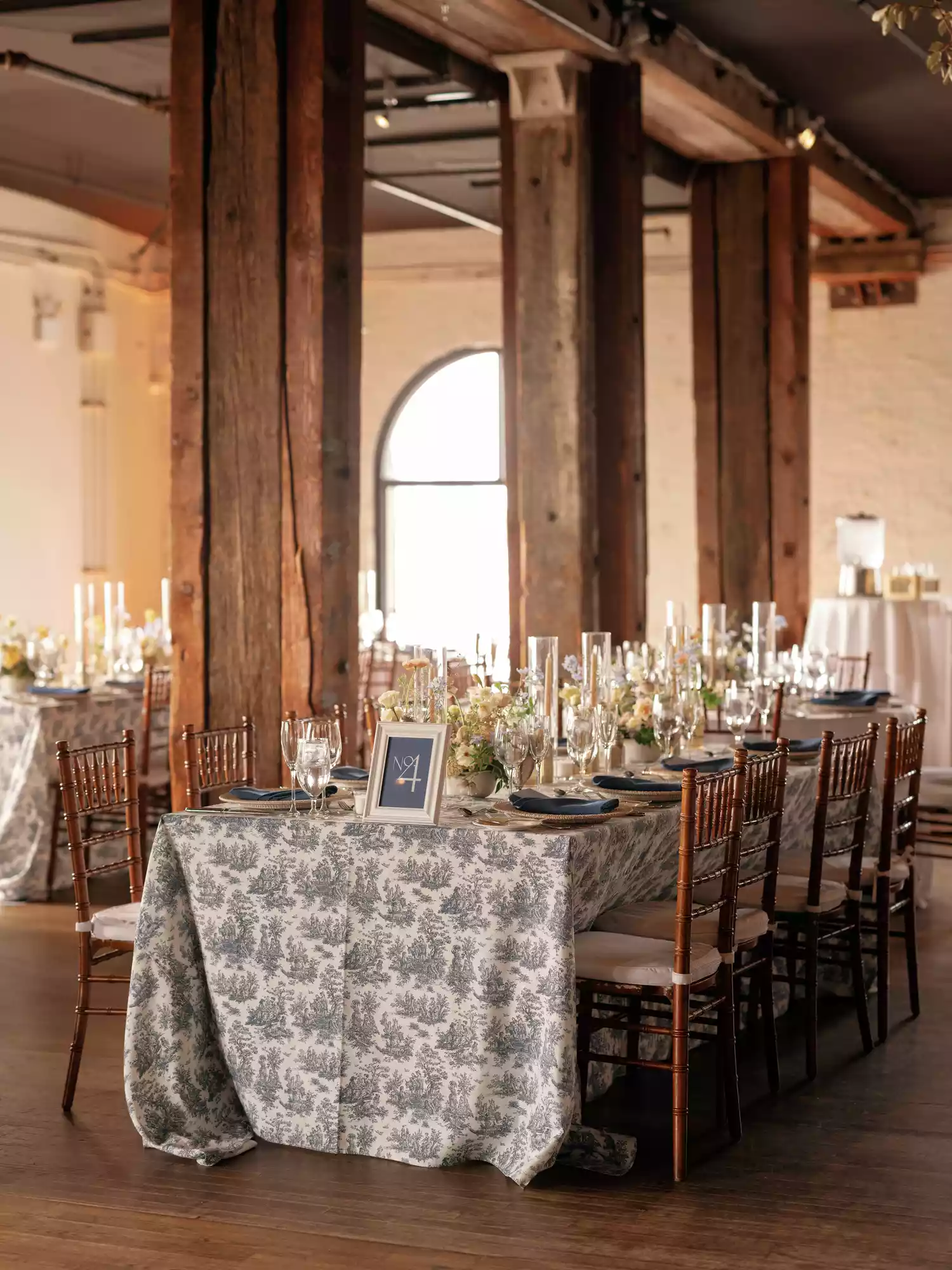 wedding reception in industrial warehouse with with blue-and-white patterned tables