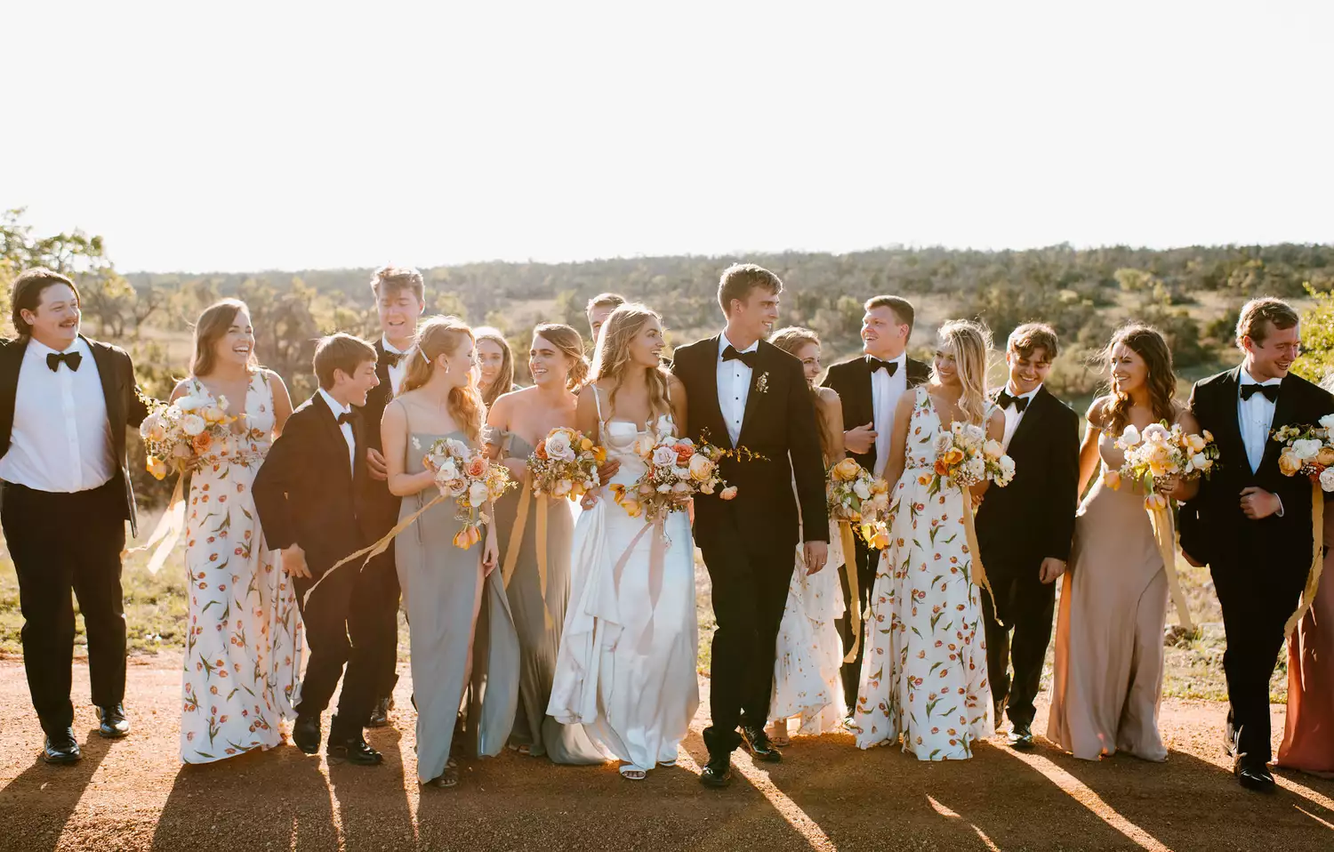 a wedding party smiling and looking at each other