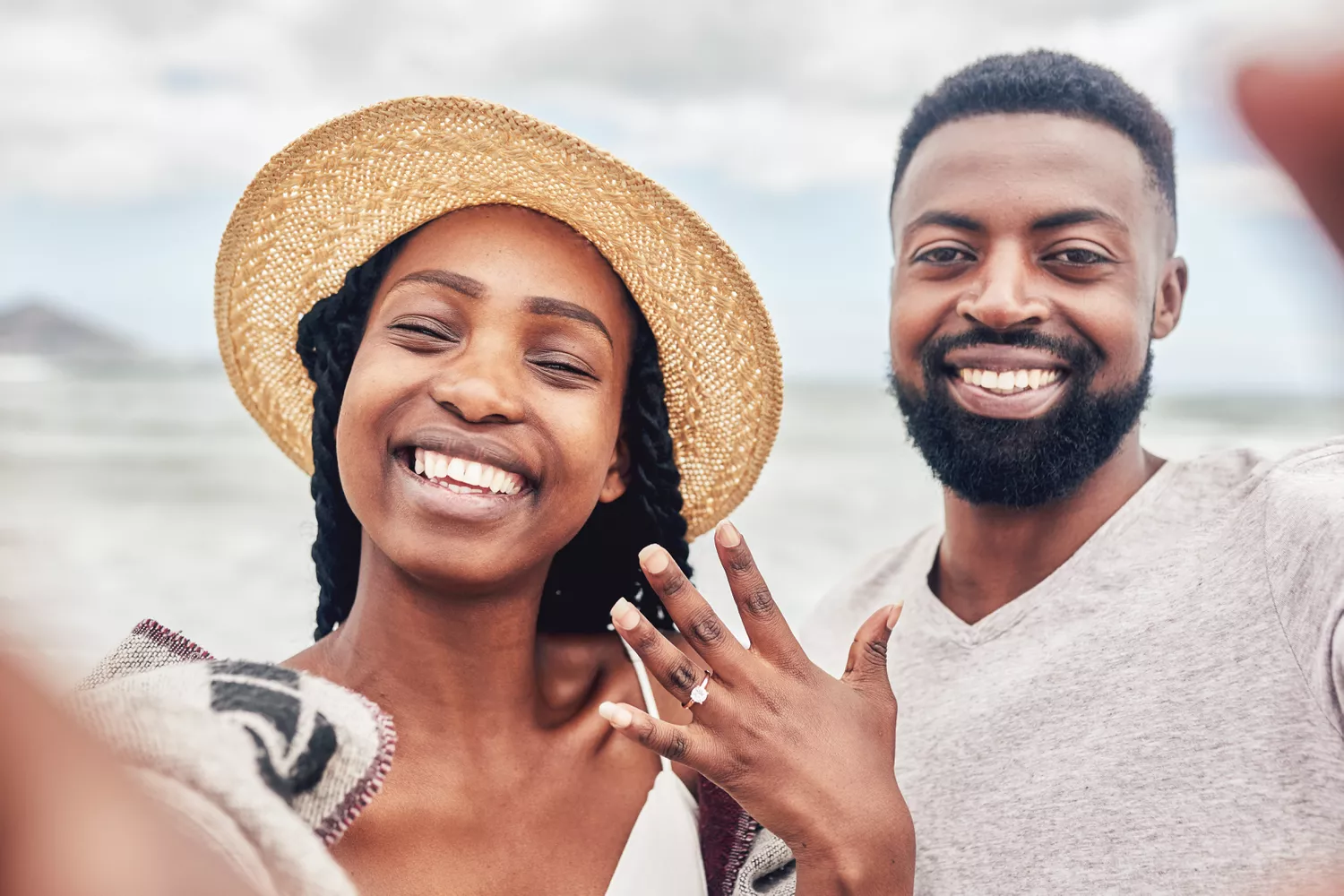 Engaged Couple on Beach Taking Selfie to Show Off Engagement Ring