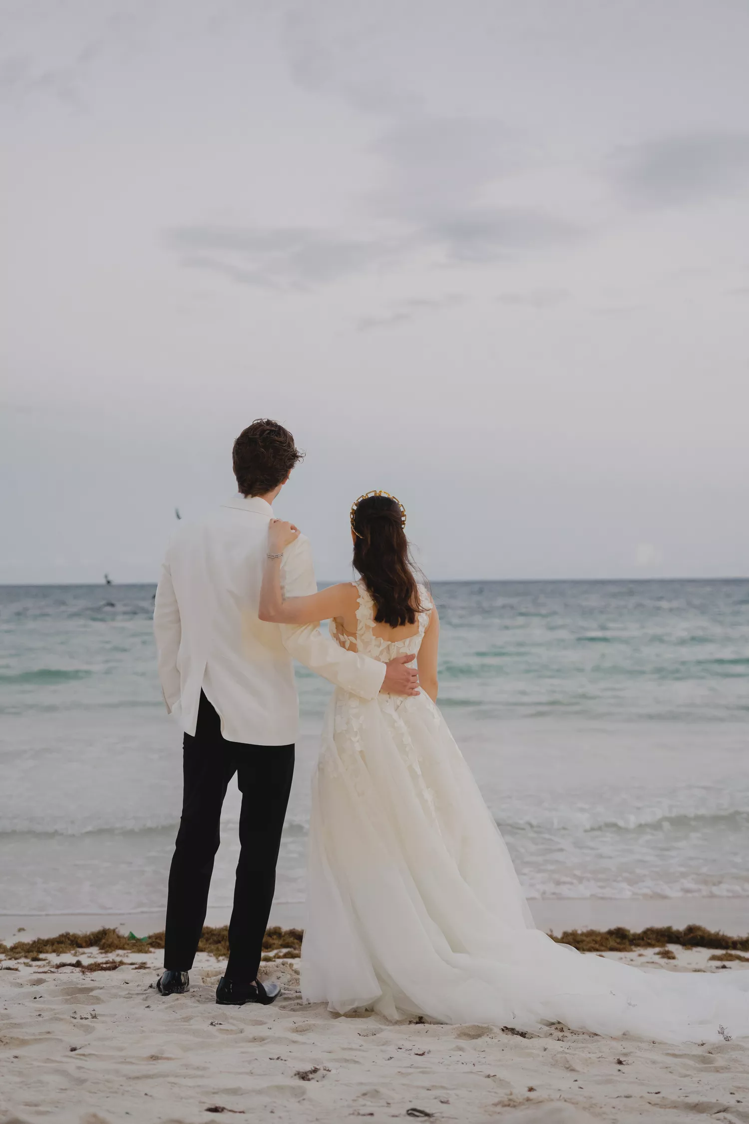 bride and groom posing for wedding portrait on the beach