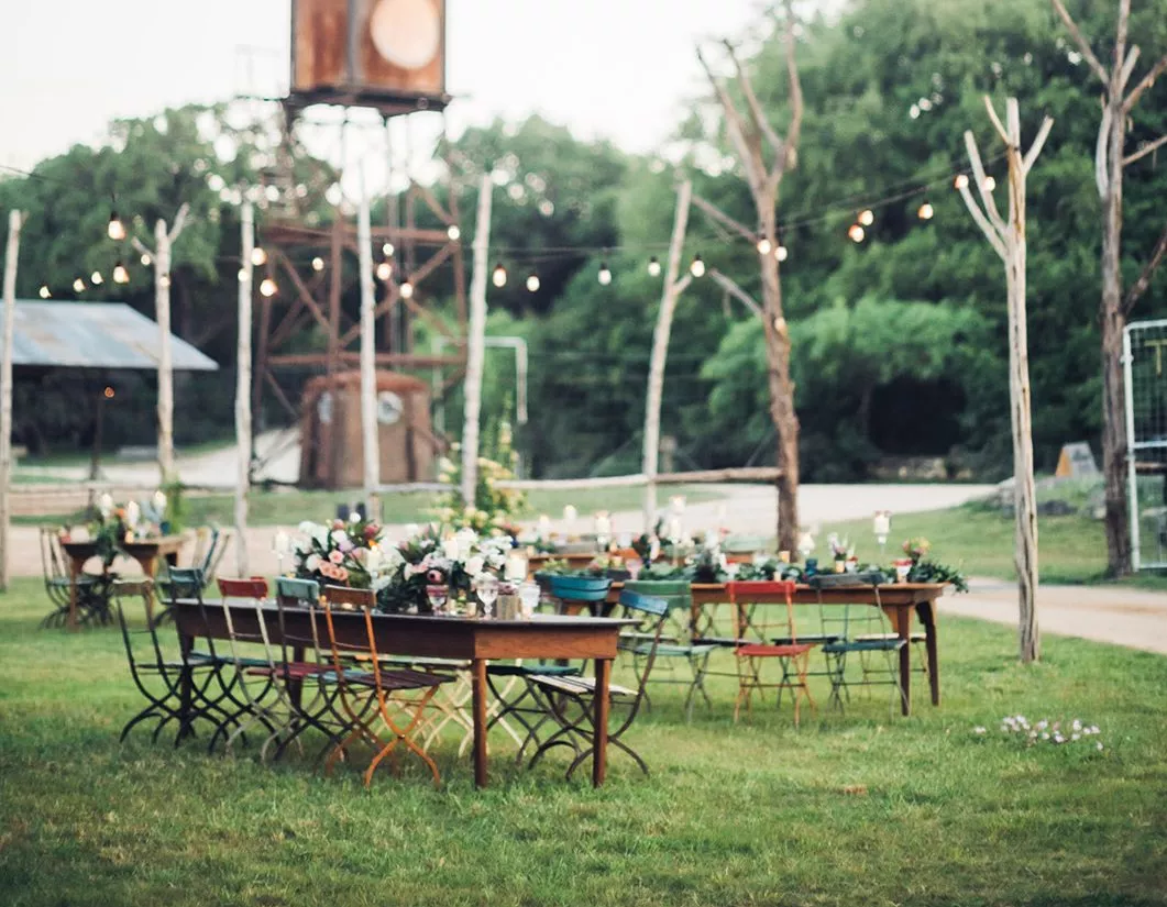 Reception tables set up on a farm for a farm wedding ceremony.