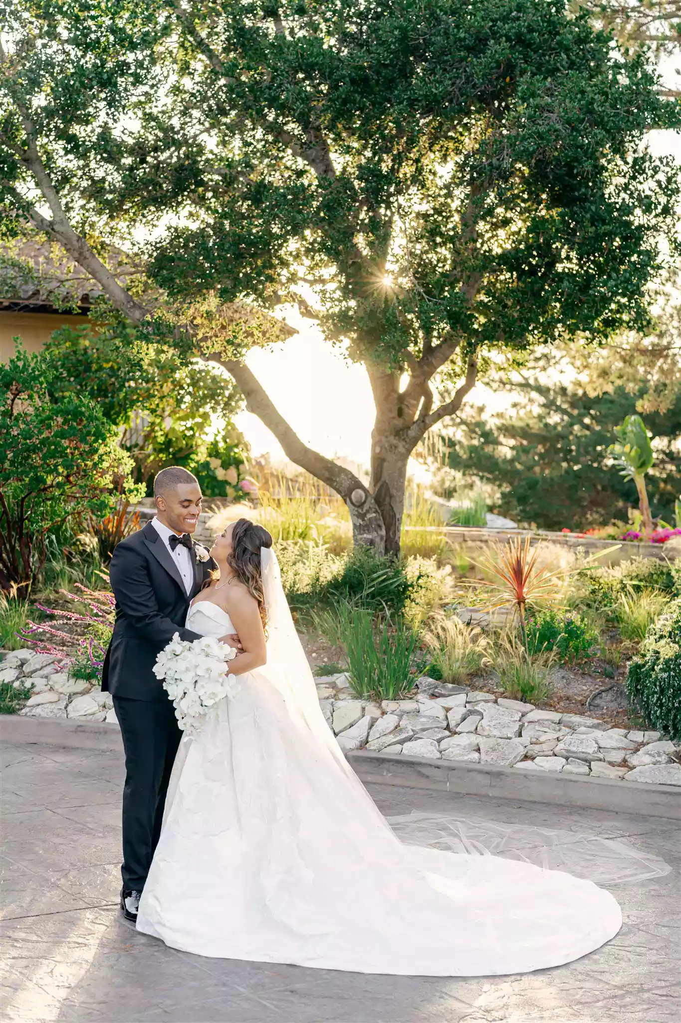 bride and groom posing while looking into each other's eyes