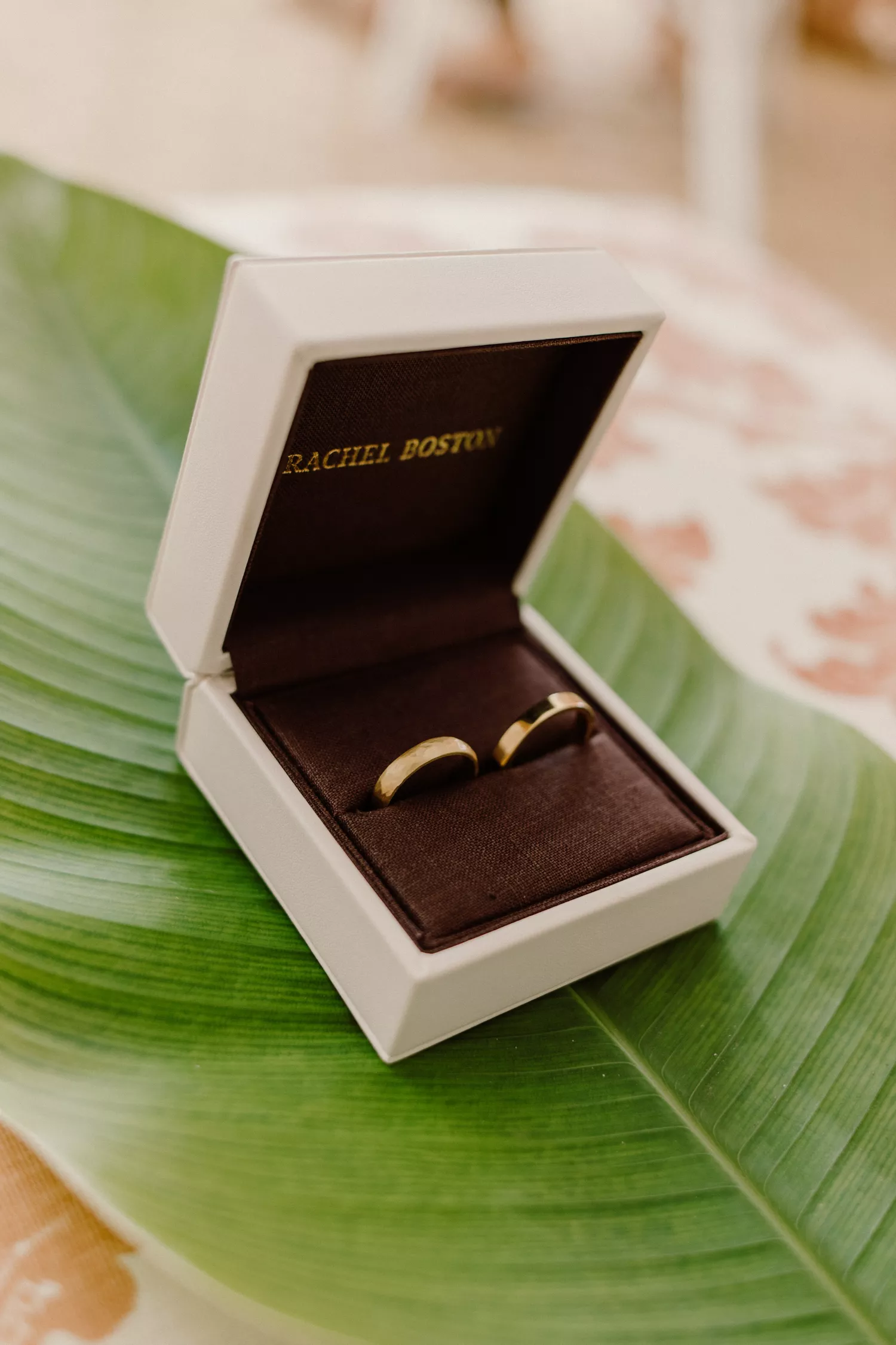 two metal wedding bands in a ring box