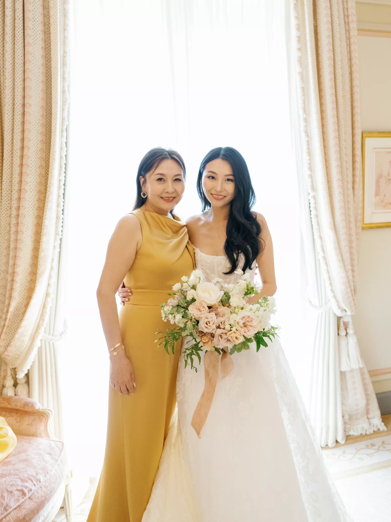 mother of the bride and bride posing ahead of the wedding