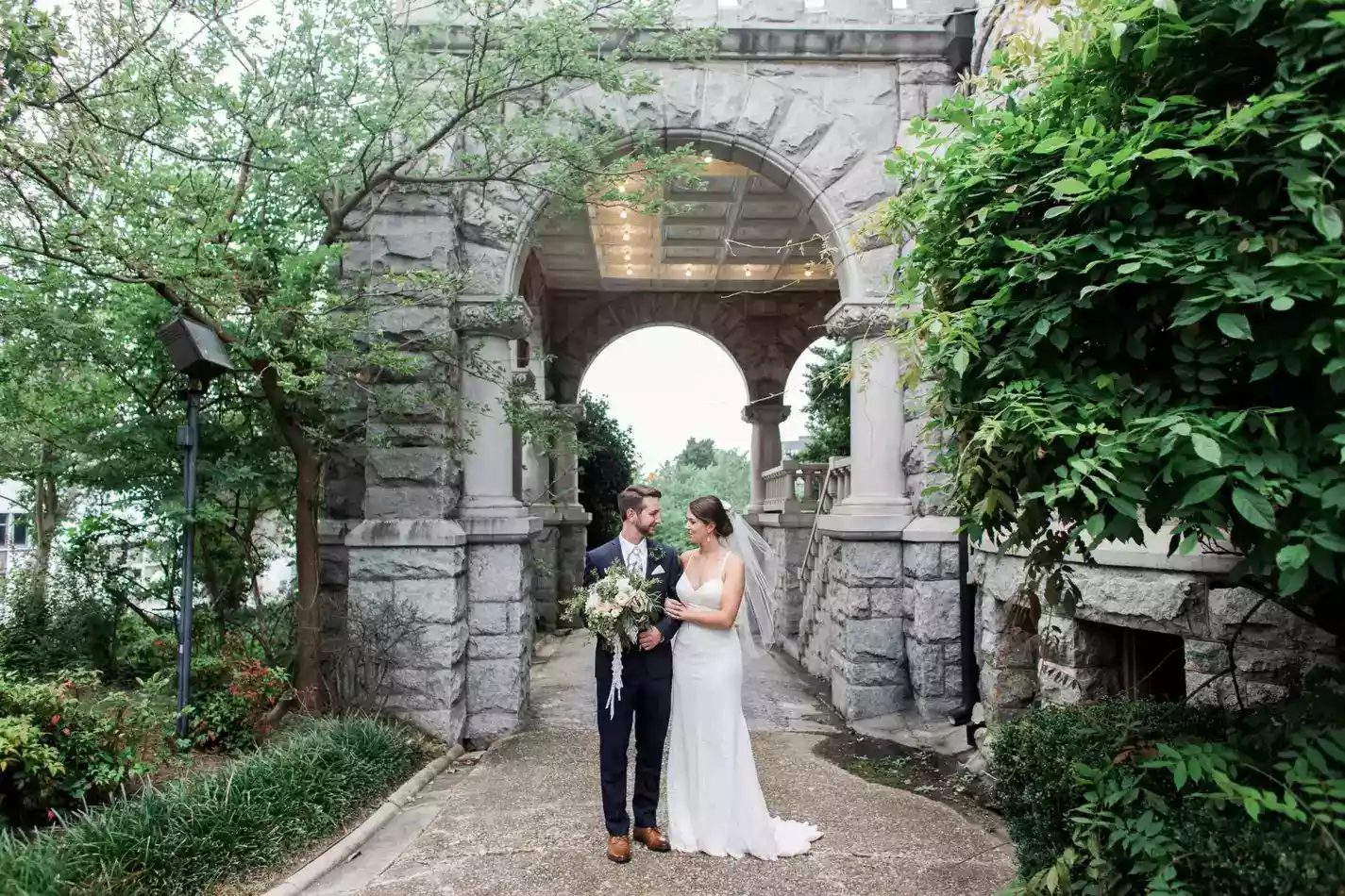Bride and groom holding hands at Rhodes Hall in Atlanta.