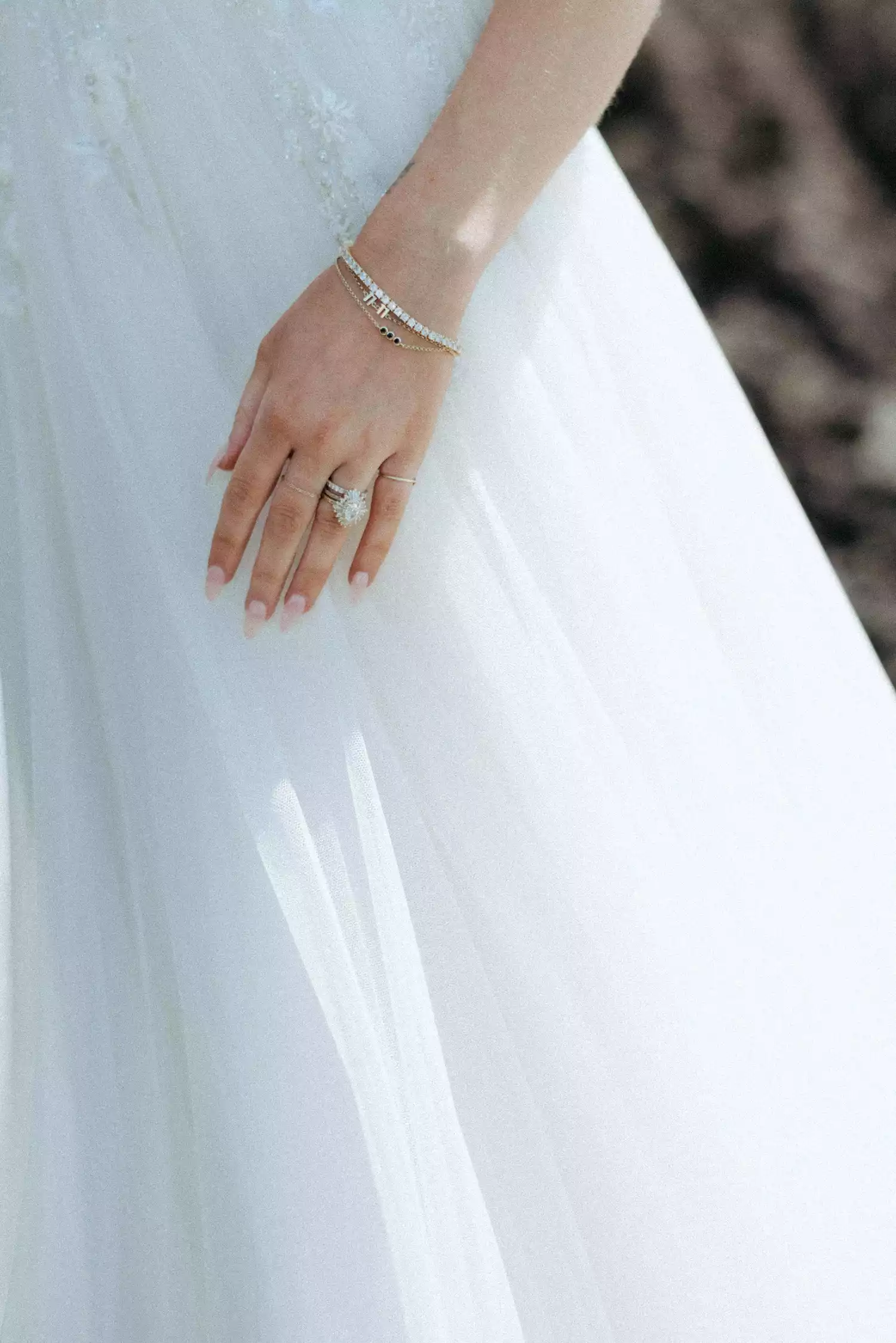 photo of a bride's hand with a wedding ring stack