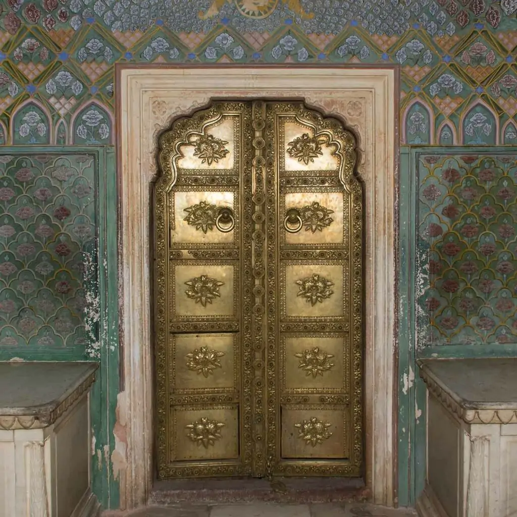 Antique pooja room door design in wood with metal work and gold plated