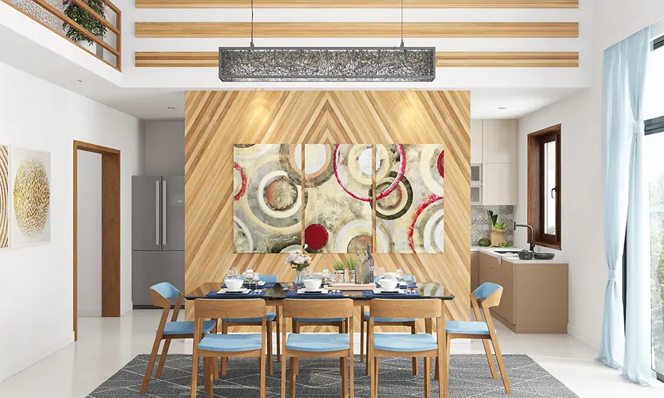 A contemporary dining room wall decor with wooden paneling and modern art pieces bring an artistic vibe
