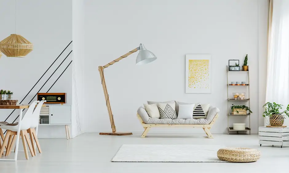 This uber-contemporary living room lamp in the corner with a wooden base and a metal shade looks classy and chic.