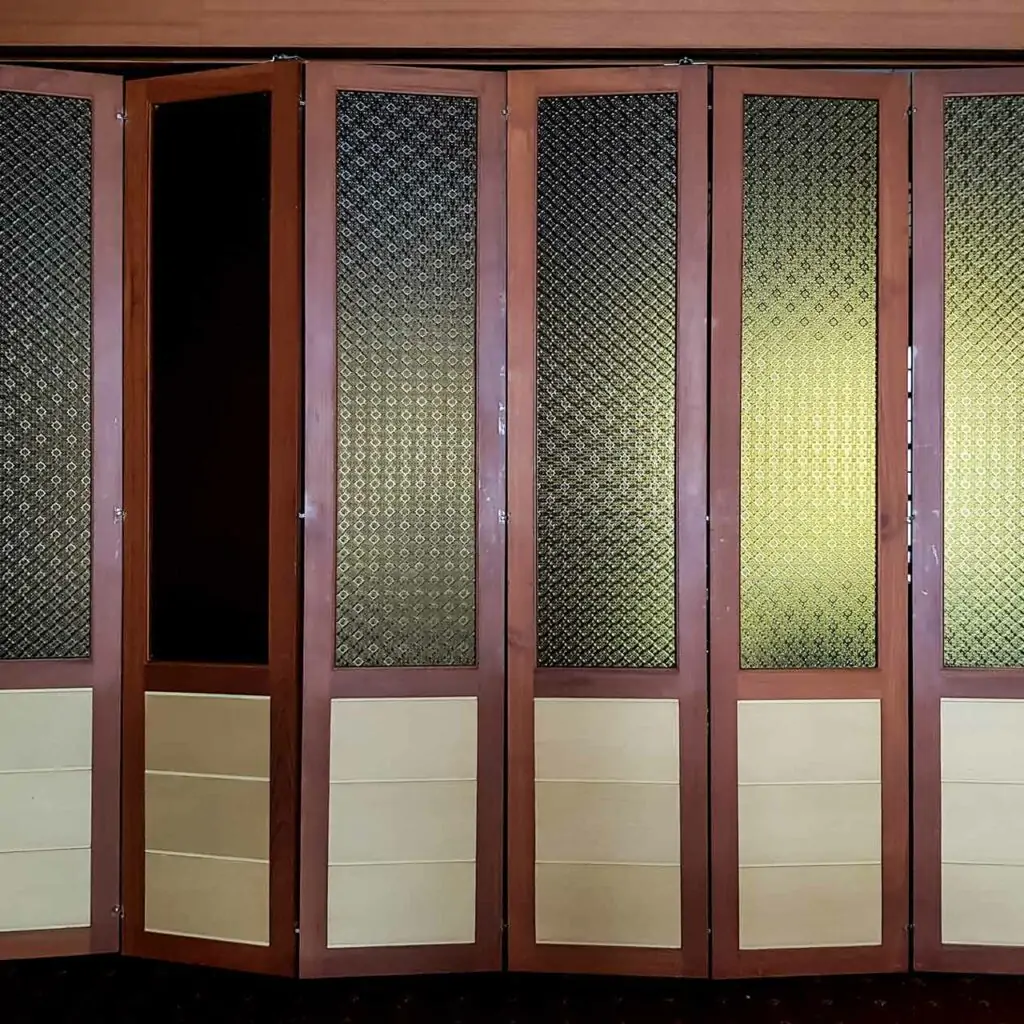 Pooja room single door designs made up of wood and a style of traditional folding