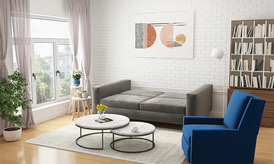 A full sized grey sleeper sofa paired with a white faux fur rug in living room