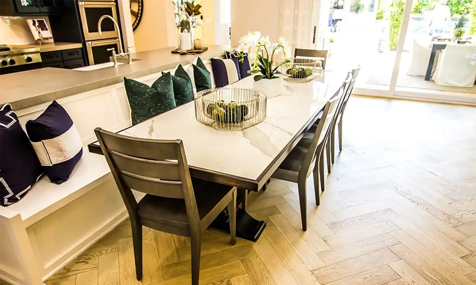 Granite stone dining table top with chairs on one side and a relaxed sitting area