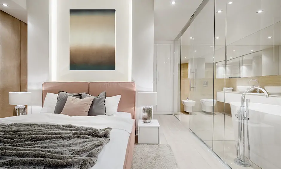 Bedroom's glass partitions and ivory-colored walls create a spacious illusion