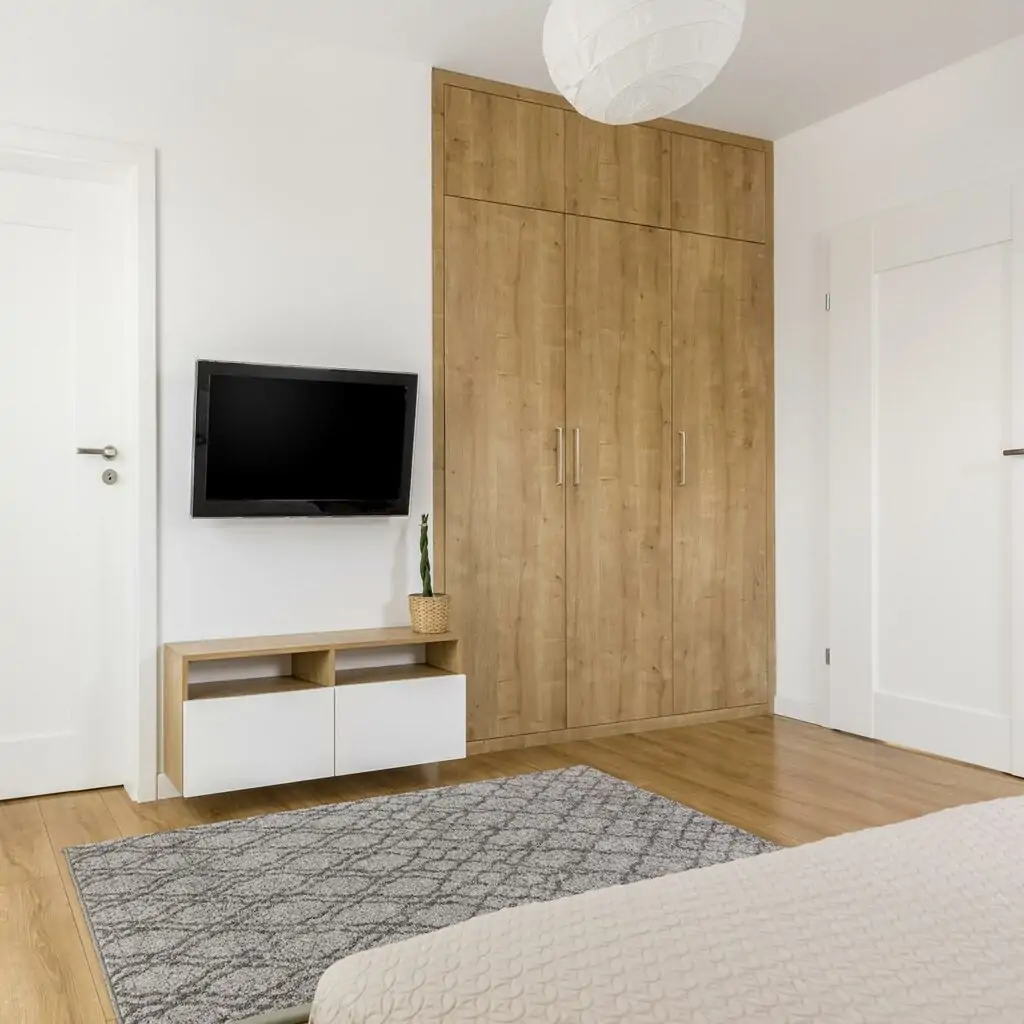 Bedroom tv wall design with bulky storage cabinets and thin racks below your tv screen