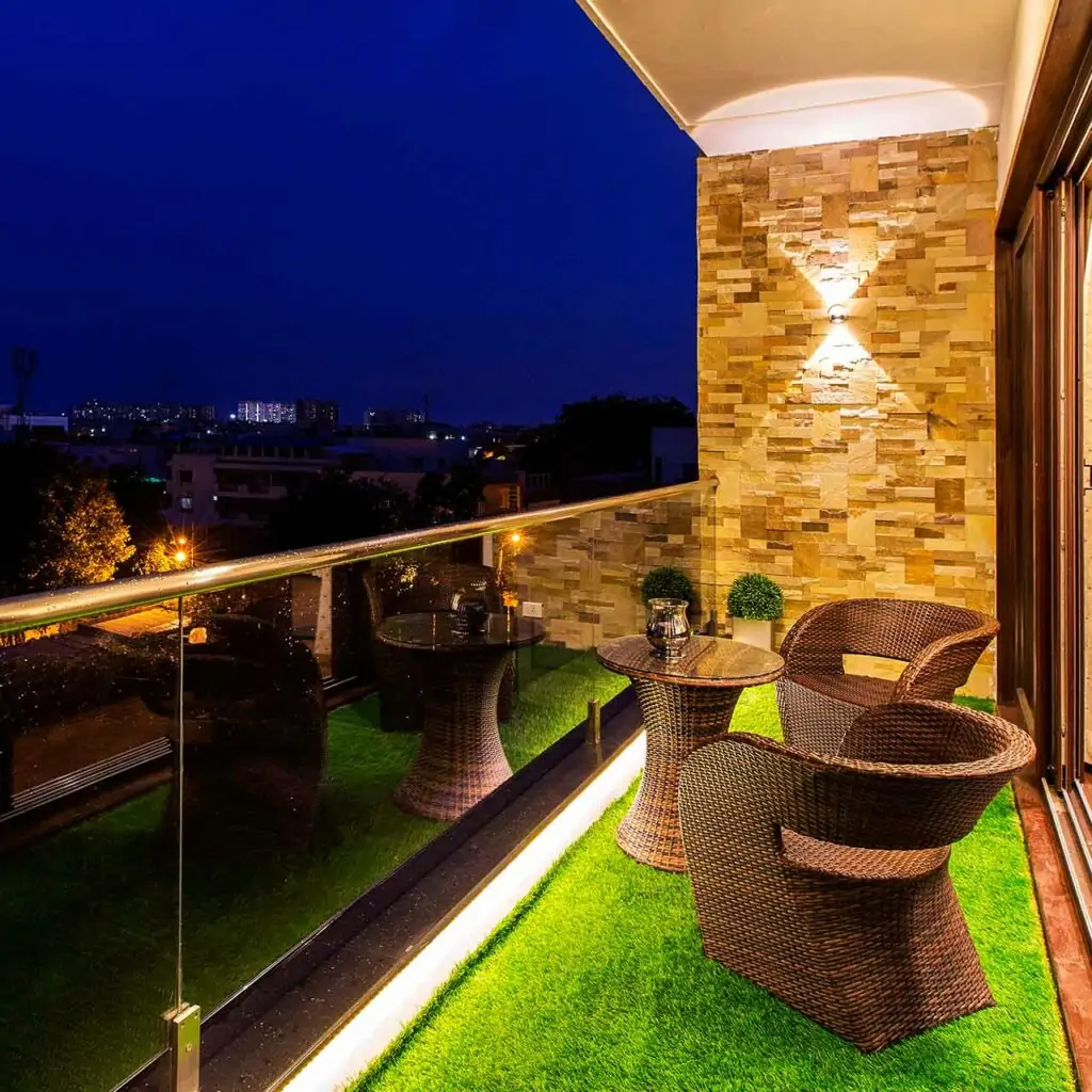 Indian balcony design with stone walls and hidden lighting set enhance the look and feel