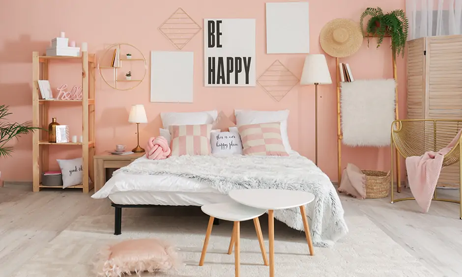 This master bedroom painted in light pink has a quirky and fun touch is light reflecting paint for dark rooms.