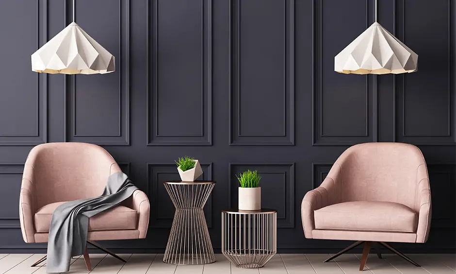 Two pink chairs against a black wall create a stunning pink and black colour combination