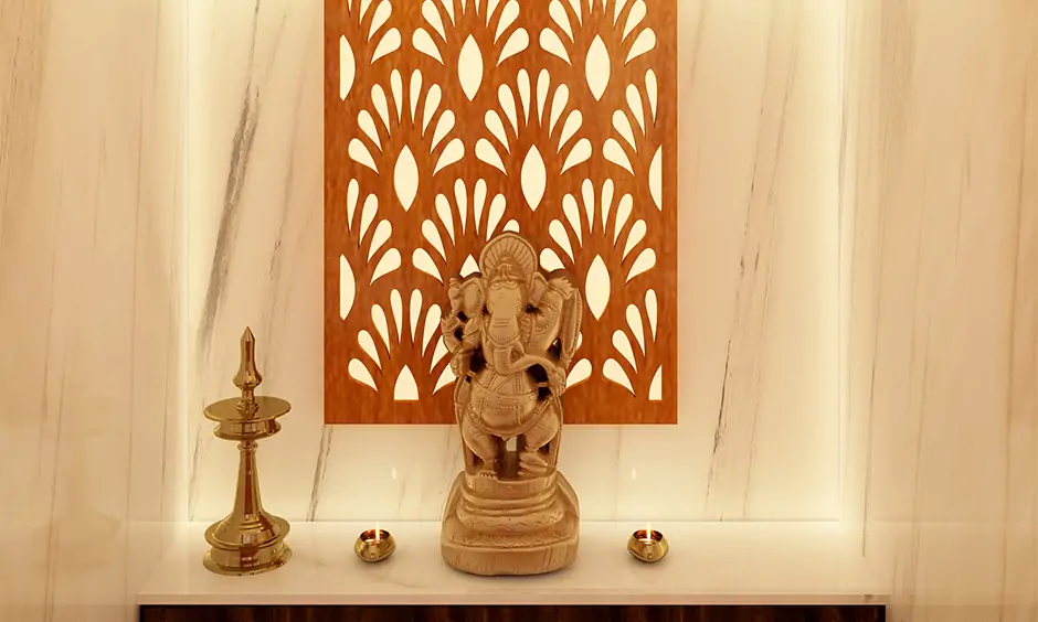 Pooja room has a traditional wooden back panel and recessed pooja mandir lights that gives a warm yet bright light.