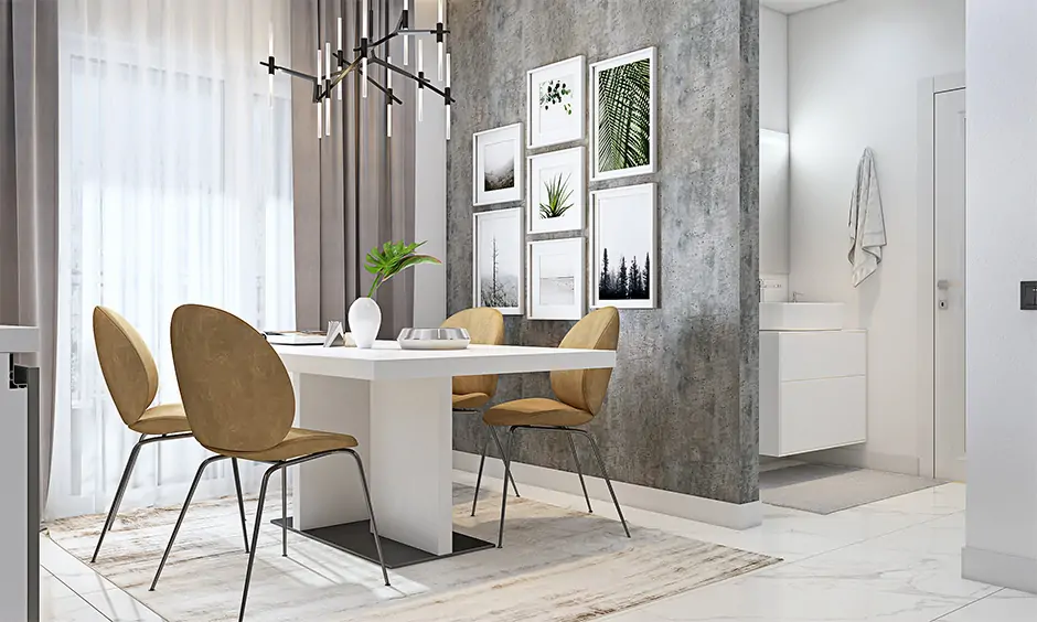 A rustic grey dining room with classic white wall art frames gives the space an industrial and modern look.