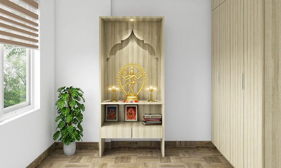 Pooja room made with light coloured plywood and has spot led lights for pooja room right above the deity look modern.