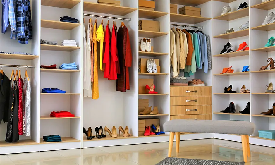 Simple, small walk-in closet design featuring colour-coded organisation for effortless outfit selection