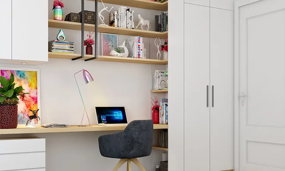 Clutter-free wall-mounted study table with bookshelf and shelves in white laminate is a stunning design.