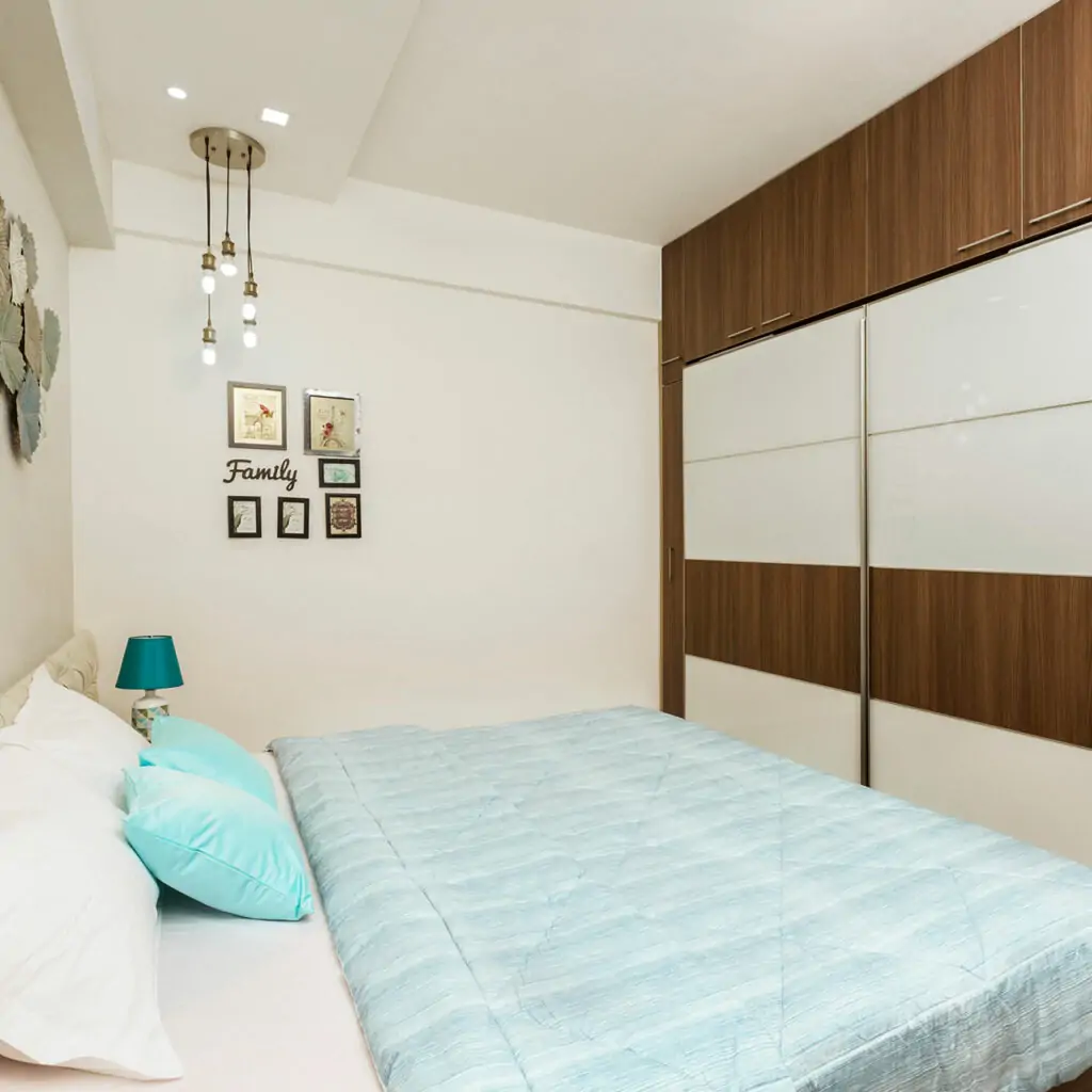 Sliding door wardrobe designs for bedroom with mirrored and patterned sliding doors combine to make the bedroom look