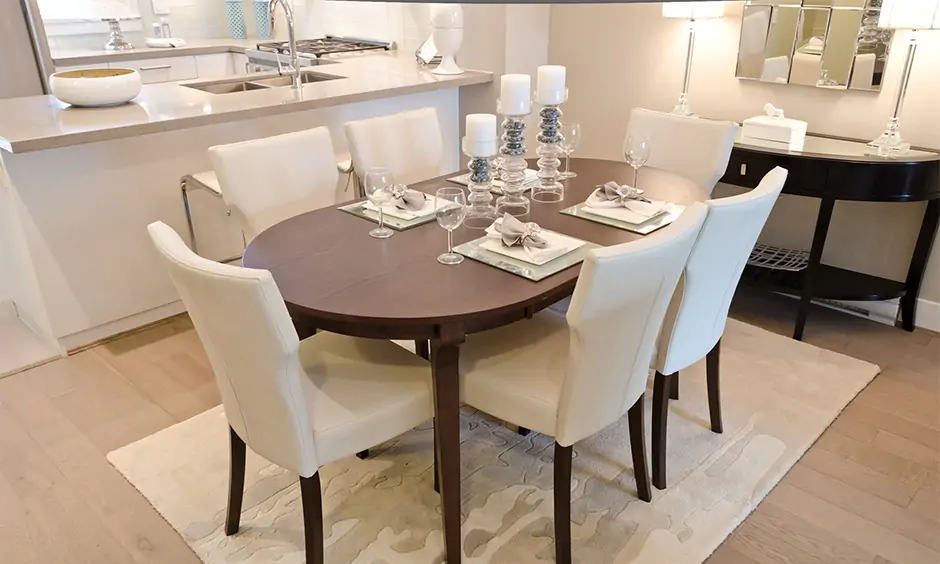 Space-saving and stylish 6-seater oval shape dining table wood paired with white chairs