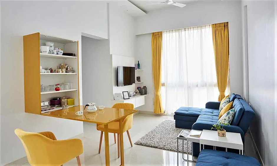 Yellow wall-mounted drop leaf table in the living room makes the space versatile
