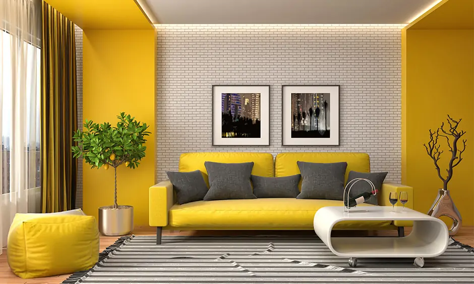 Yellow accent wall color with grey interiors adds a vibrant twist