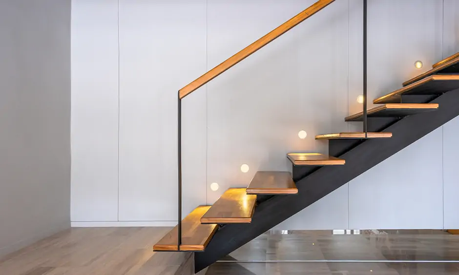 Wooden staircase with inlaid led lights fitted into the wall embellishes a modern home is the staircase lighting ideas