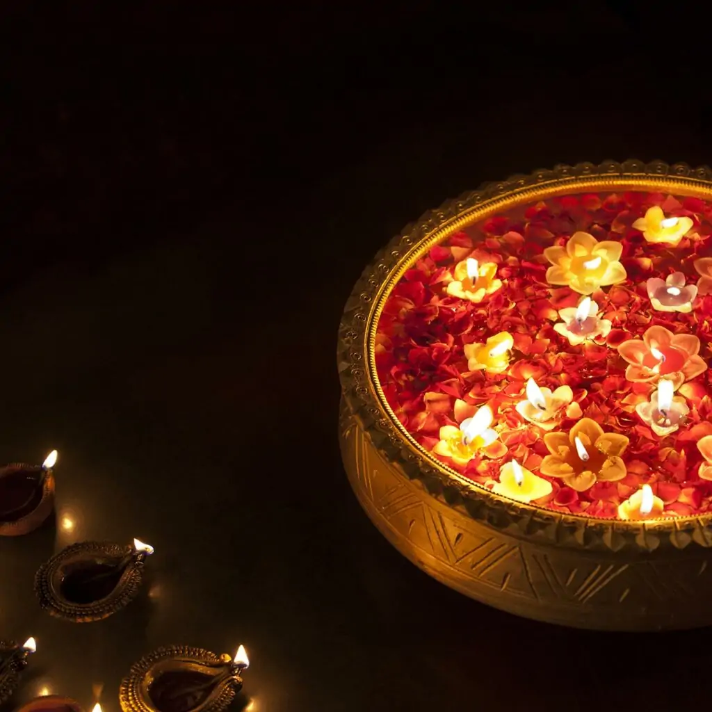 Flower petals with floating diyas in a large bowl is a beautiful decoration you can place across the home