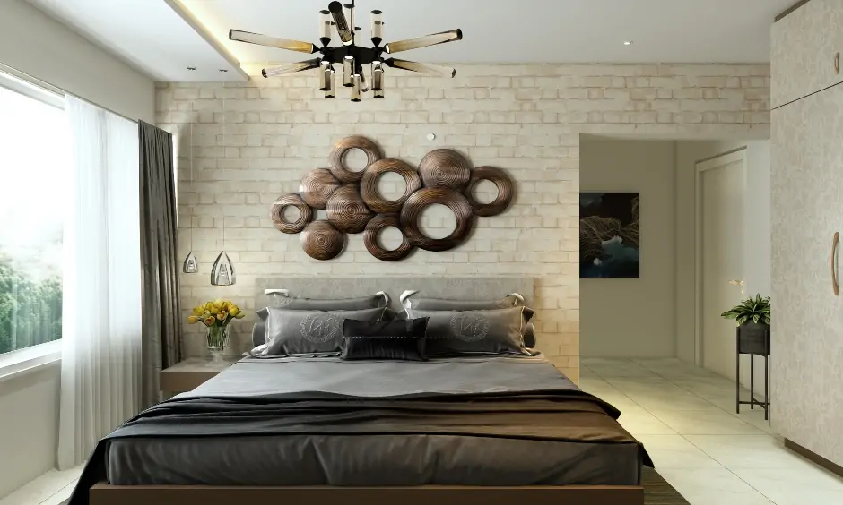 Elegant bedroom designed with a stone wall cladding tiles in a light hue enhances the look of space