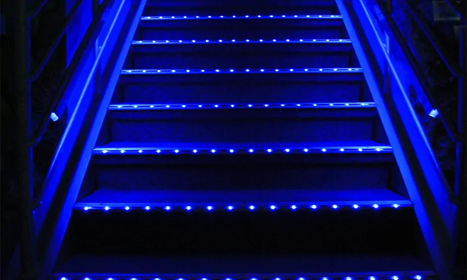 Staircase with tiny blue neon light strips adds an element of fun to space is led lights for staircases idea