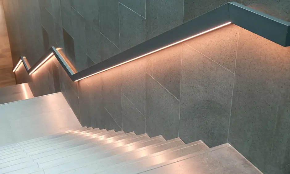 Staircase wall light designed under the railing with led strip transforms home into an abode of calm and serenity