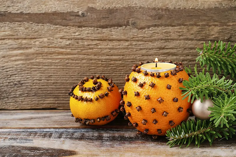 Diy oranges garnished with cloves as diy christmas decoration