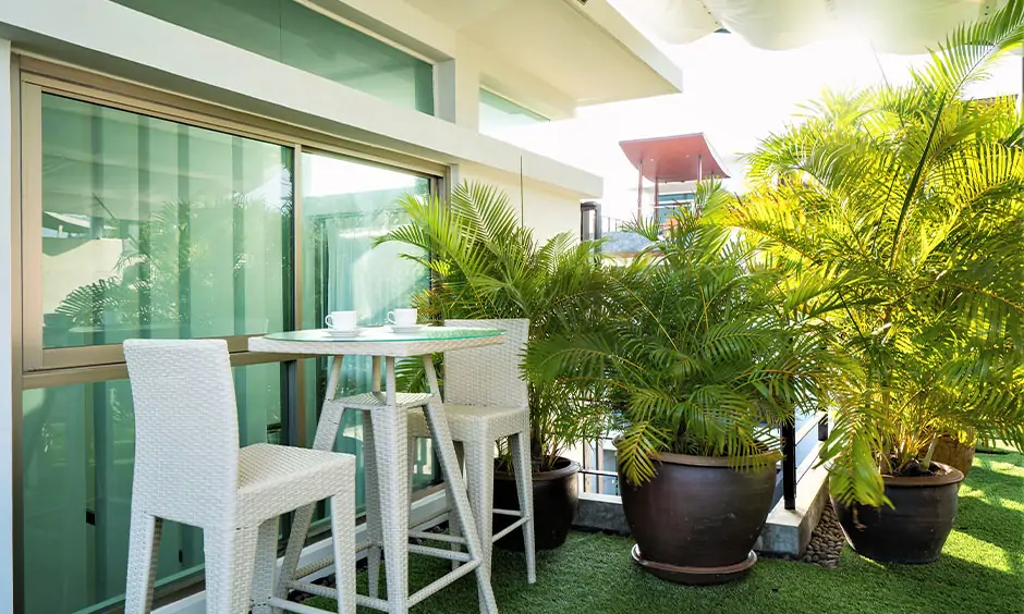 Seating on a balcony in cafe garden-style with tall chairs and a glass-top table looks gorgeous.