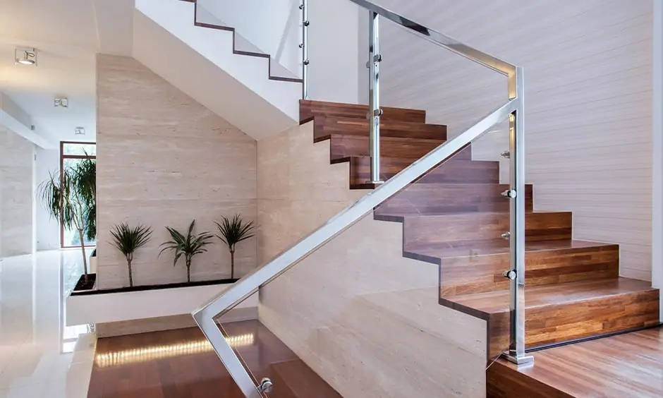 Stainless steel and glass staircase design lends modern and rustic look