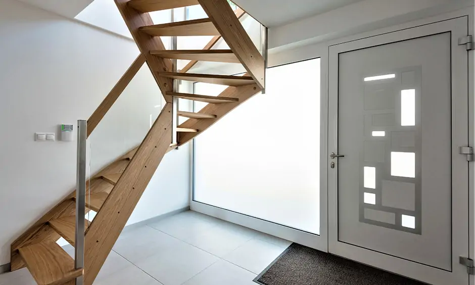 Wooden stair railing with glass and steel lend a modern yet mid century vibe